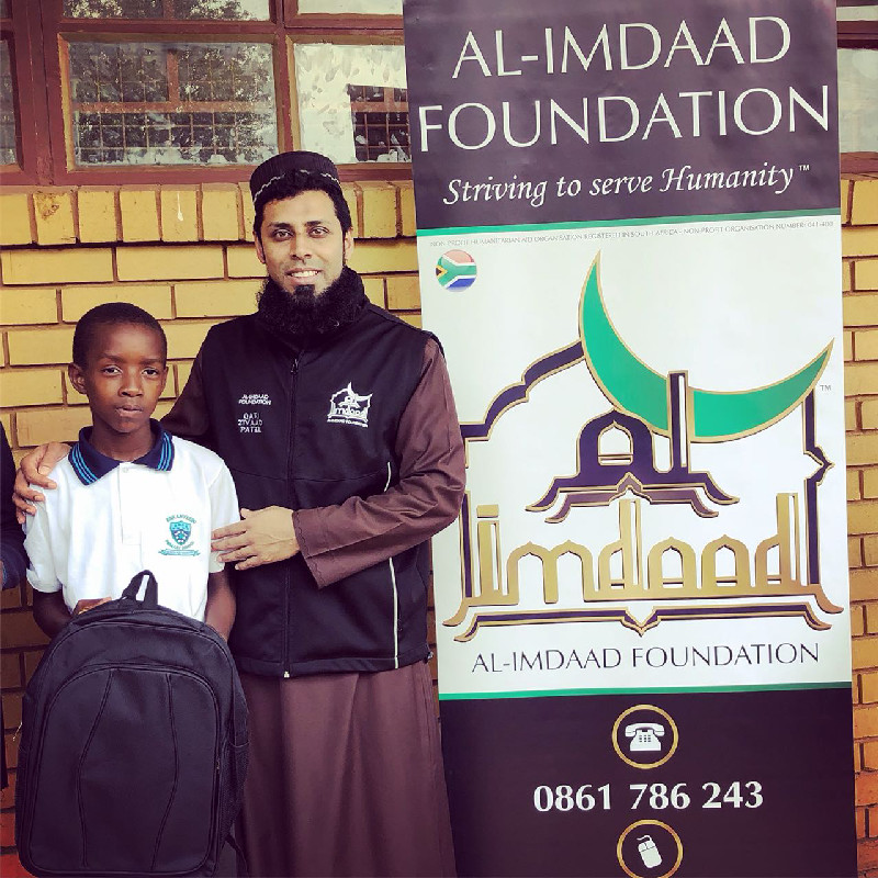 Al-Imdaad Foundation’s Qari Ziyad Patel together with a learner during a recent Back-2-School distribution in Soweto 